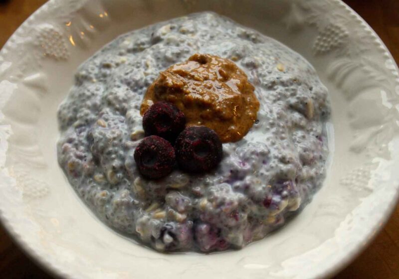 vegan chia pudding recipe in a bowl with almond butter and blueberries on top