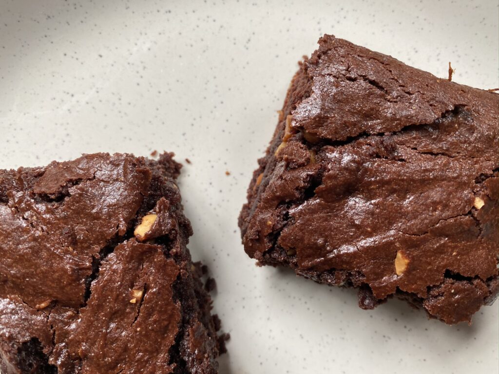 close up of two pieces of vegan brownies