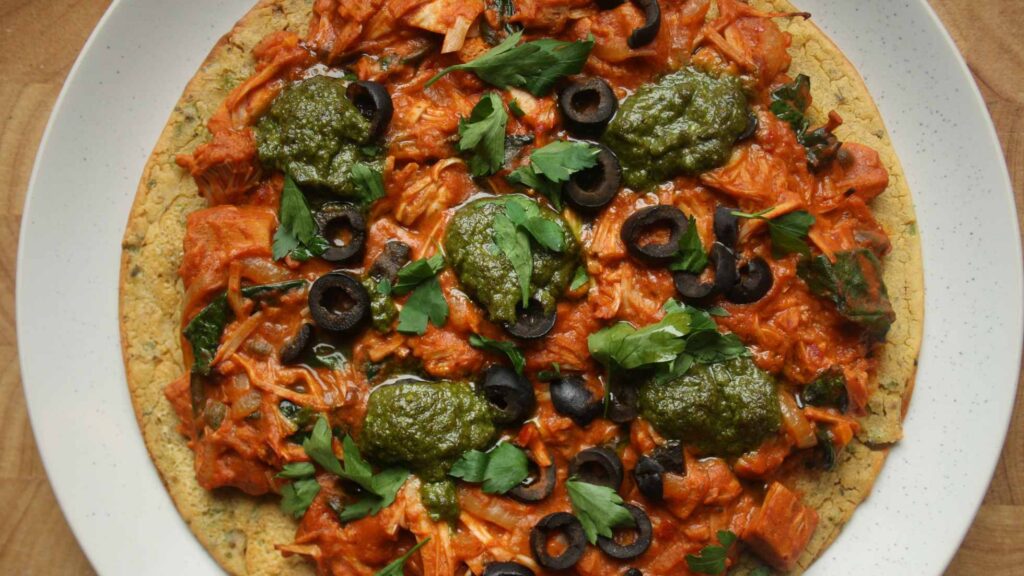 Aerial view of vegan socca pizza cooked with plant-based toppings