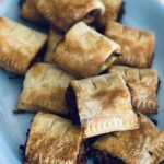 A blue plate filled up with vegan sausage rolls