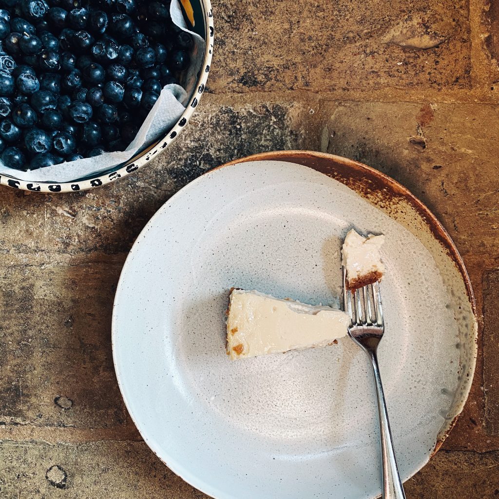baked vegan cheesecake served with blueberries