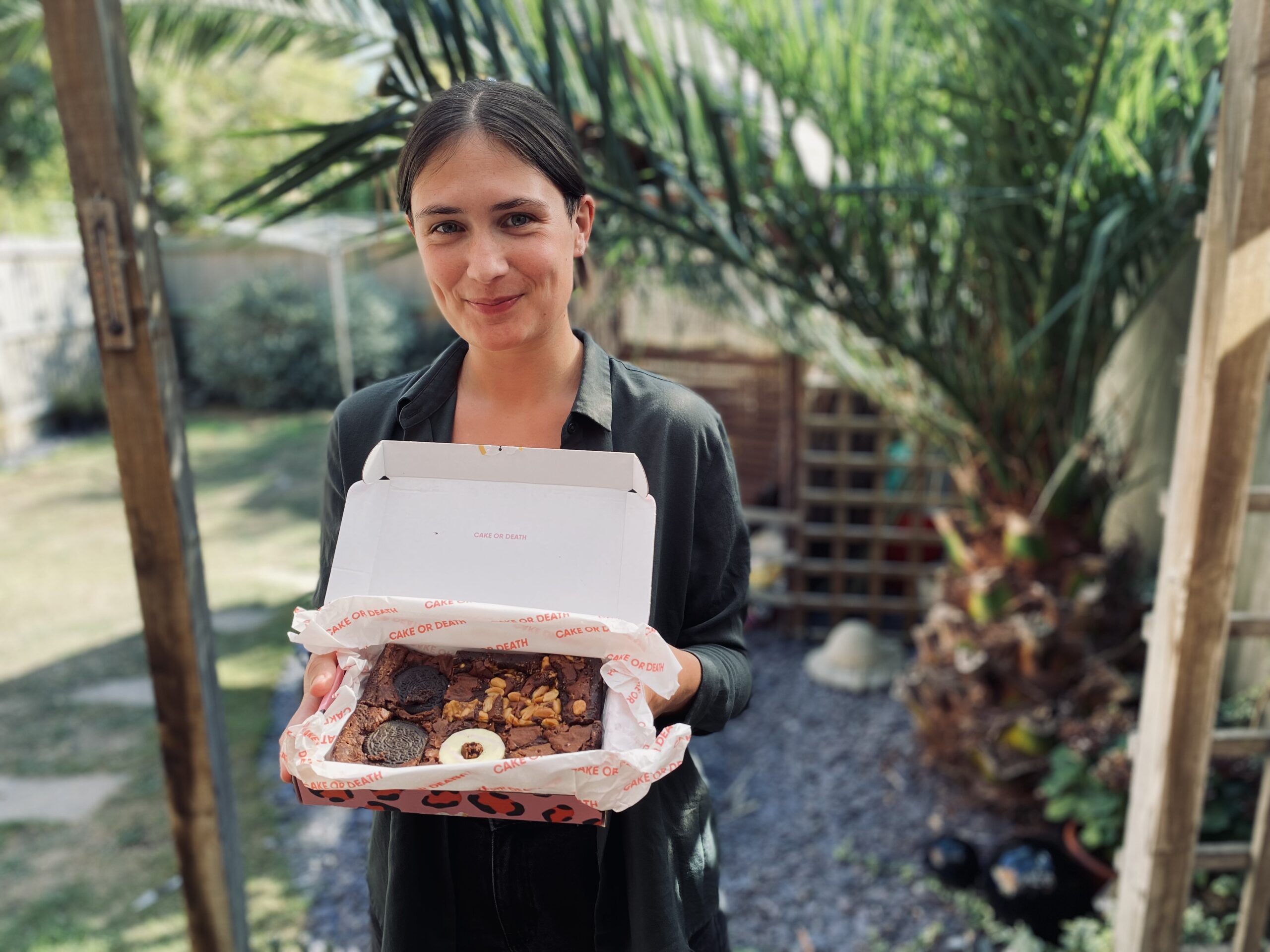 Lucy with a box of cake or death vegan letterbox brownies