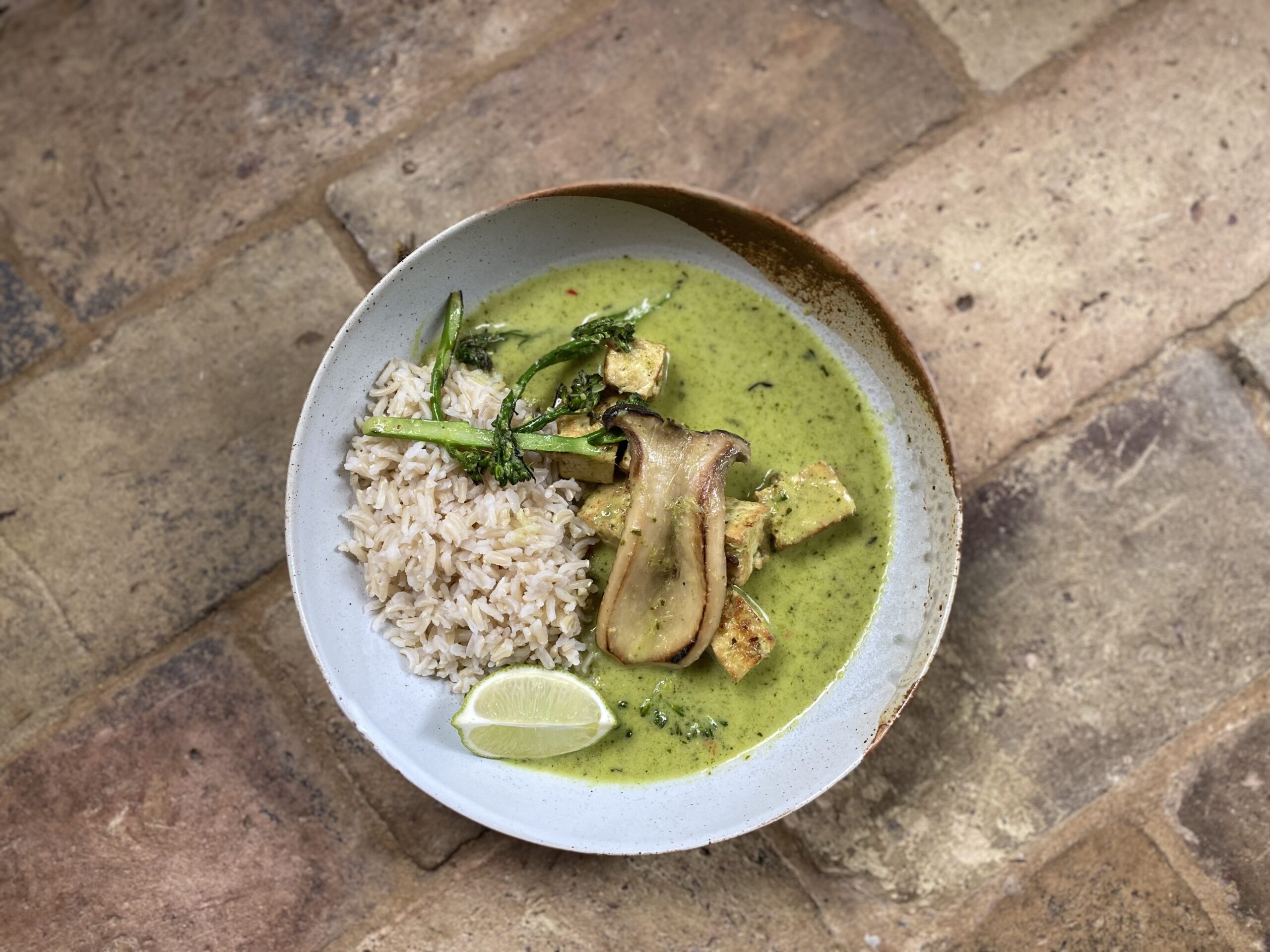 vegan thai green curry with tofu, rice and broccoli in a bowl