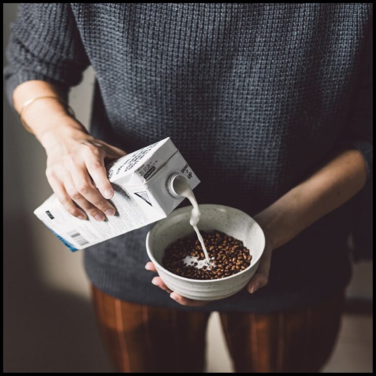 A carton of Rebel Kitchen plant-based milk being poured into a bowl of vegan cereal