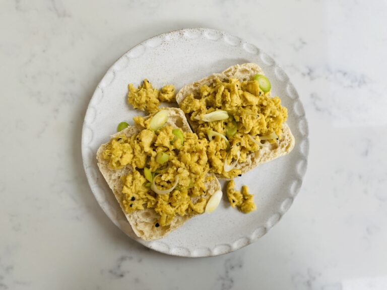 A plate of vegan scrambled egg on ciabatta bread