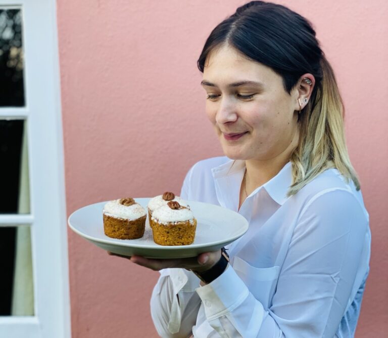 Lucy looking proud about her vegan cupcakes after following vegan cooking tips