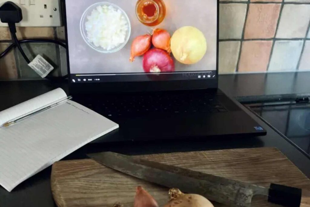 Forks over knives online vegan cooking classes open on my laptop in front of a chopping board and knife ready for learning