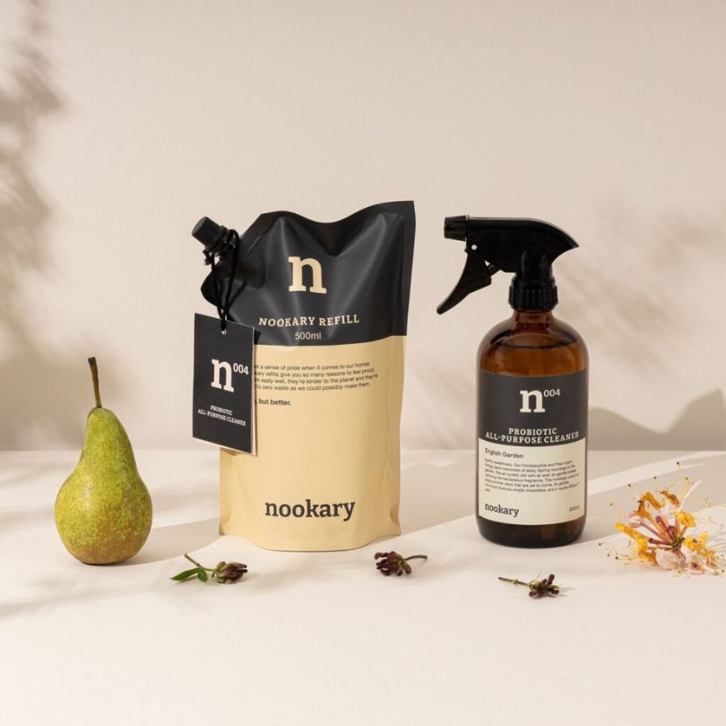 A spray bottle and refill pack of vegan cleaning product from Nookary