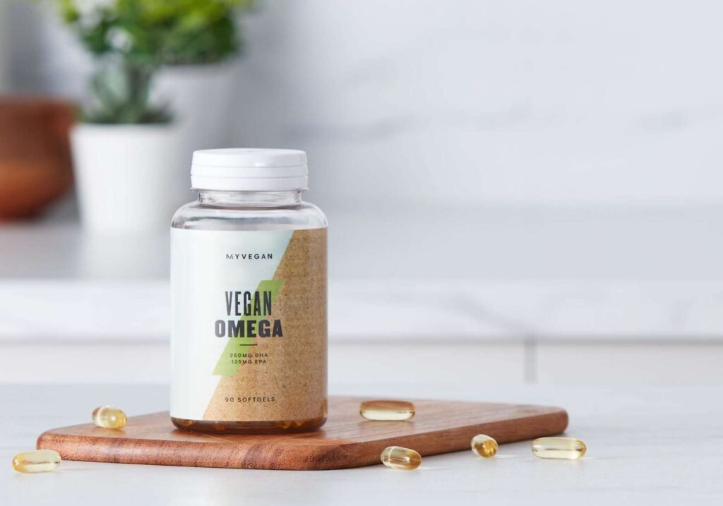 A tub of vegan supplements from MYVEGAN on a white kitchen worktop