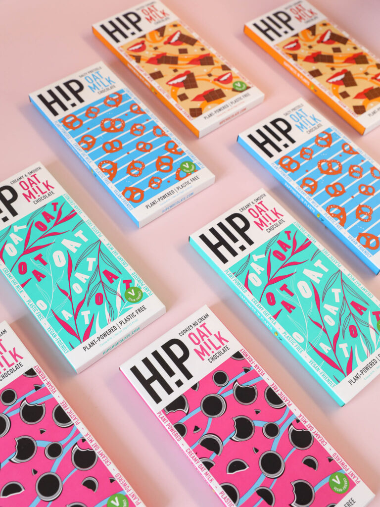 hip oat milk vegan chocolate bars laid out on a pink background