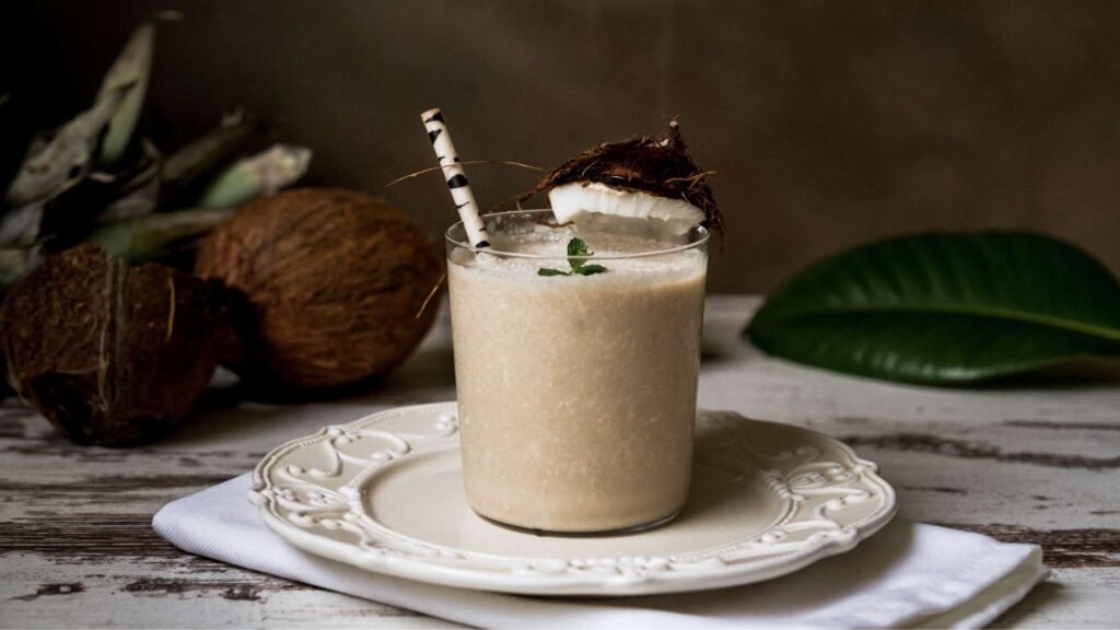 A vegan coconut drink on top of a white plate