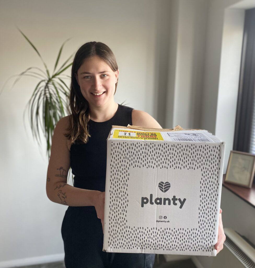 Lucy holding a delivery box of Planty vegan meals