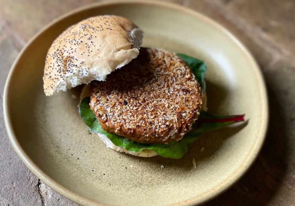 Vegan jackfruit chicken-style burger on a rustic plate