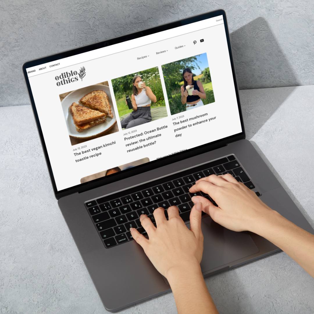 A woman browsing on a laptop with the pinned sponsored posts at the top of the homepage