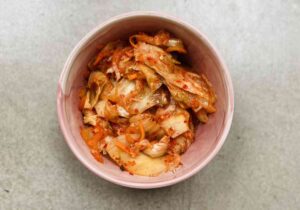 A bowl of probiotic rich food, kimchi that helps to improve gut health