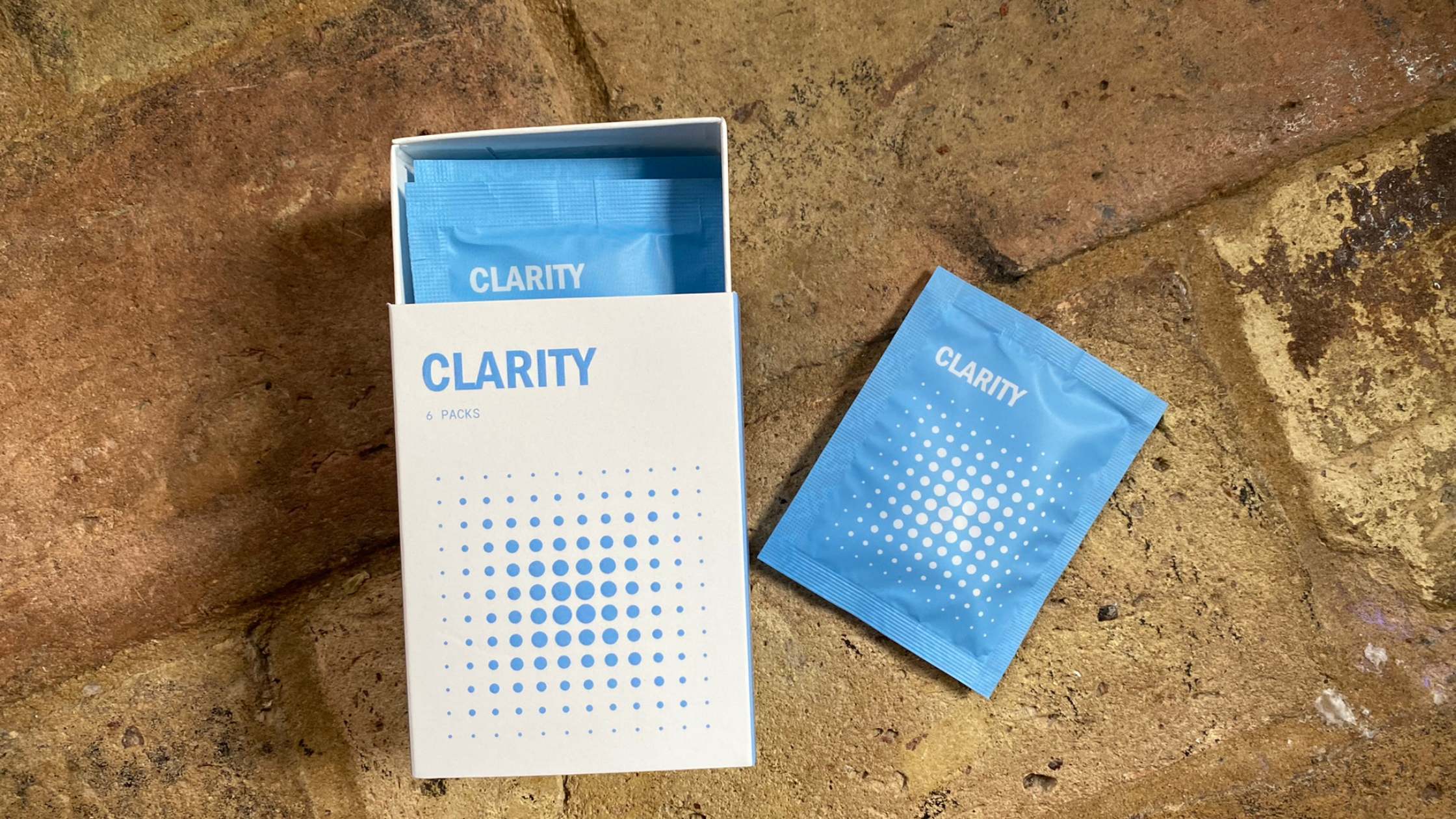A box of Thesis Clarity lion's mane supplements with the sachet containing the pills to the right
