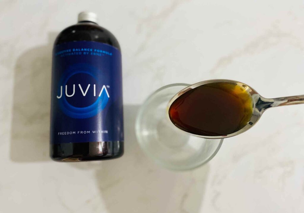 A spoonful of Juvia infront of the bottle for this Juvia review