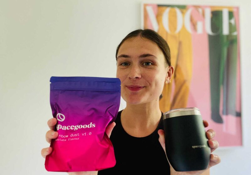 Lucy holding a bag of spacegoods and the spacegoods thermal cup for this Spacegoods review