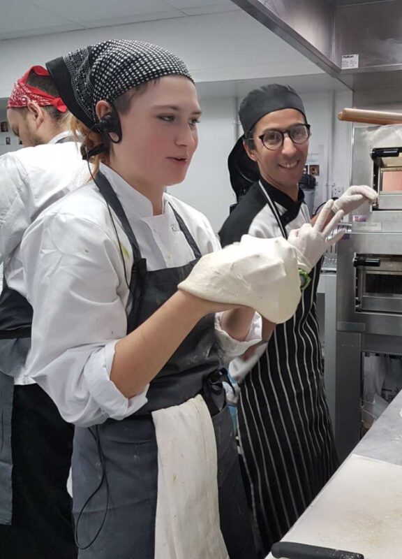 Lucy in her chef uniform at a vegan chef job