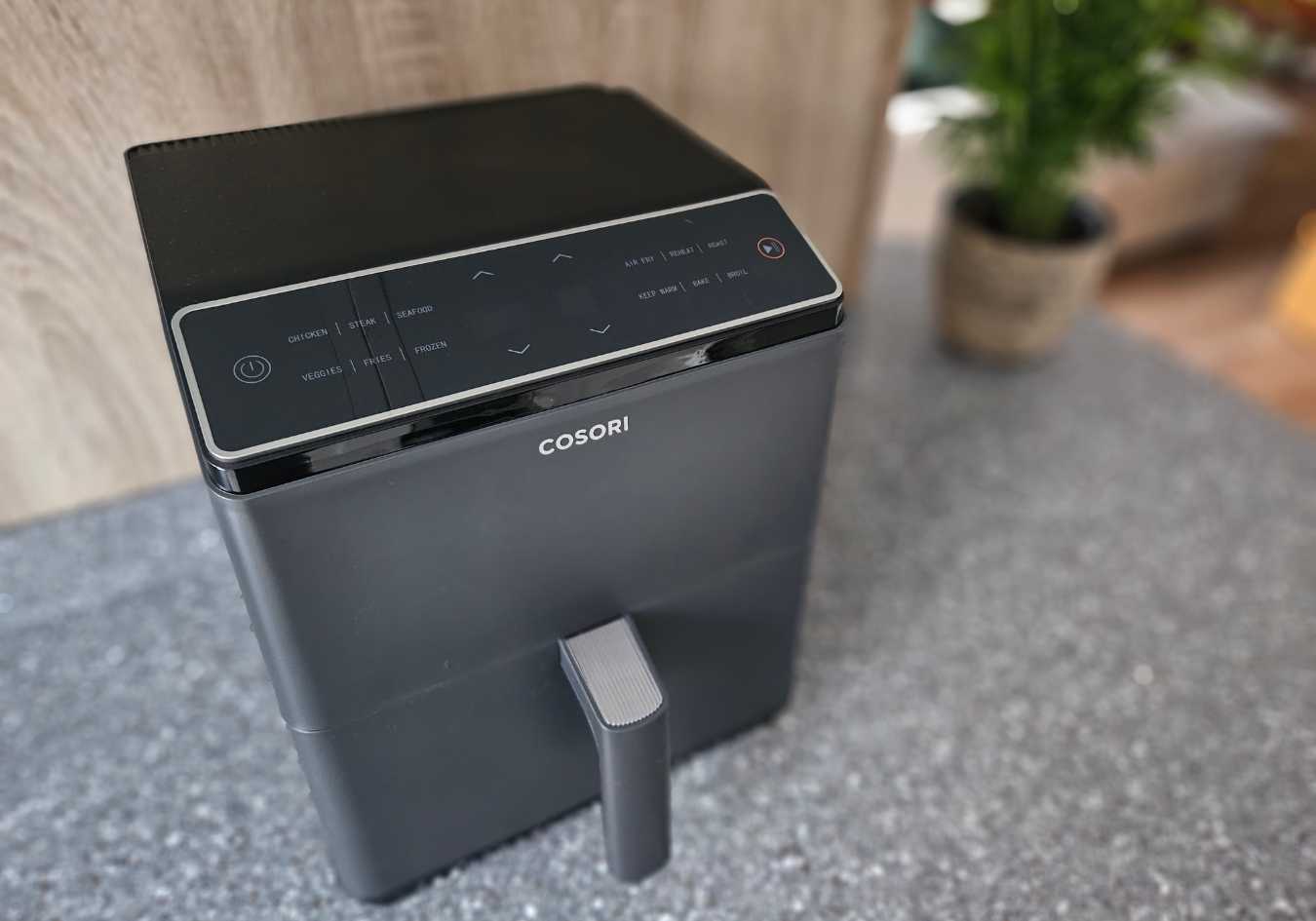 The Cosori air fryer on top of a kitchen counter top for this Cosori air fryer review