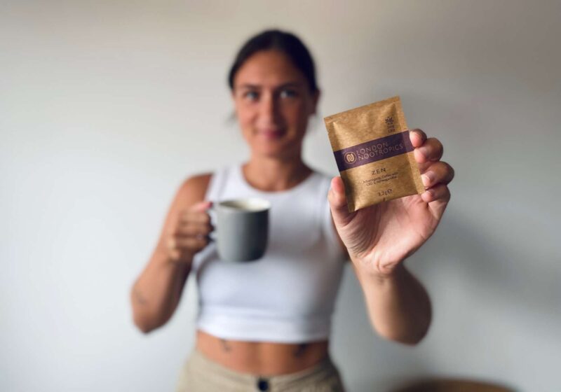 Lucy holding up a sachet of London Nootropics CBD coffee some of the best CBD in the UK